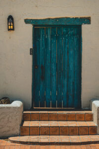 Stoop built up over stucco siding with planters on each side